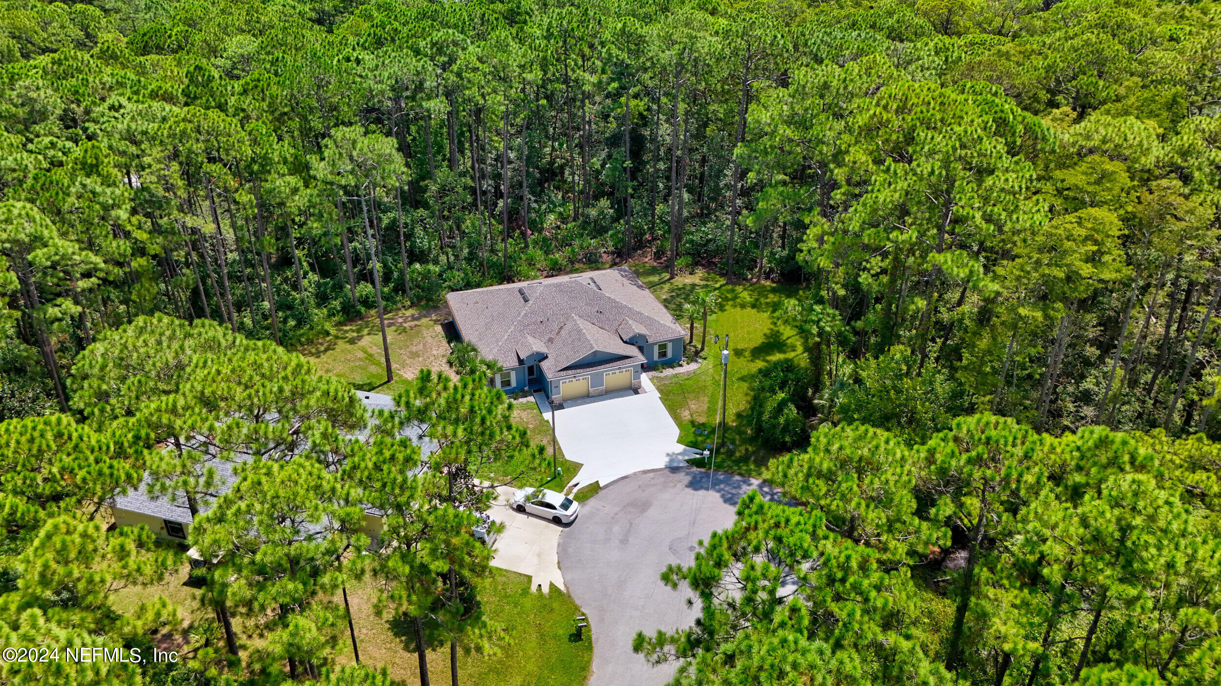 an aerial view of a house with yard and outdoor seating