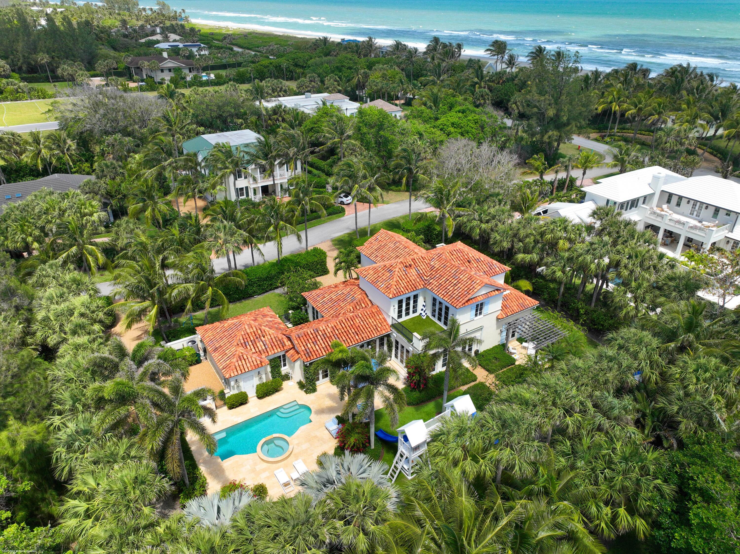 an aerial view of residential houses with outdoor space and street view