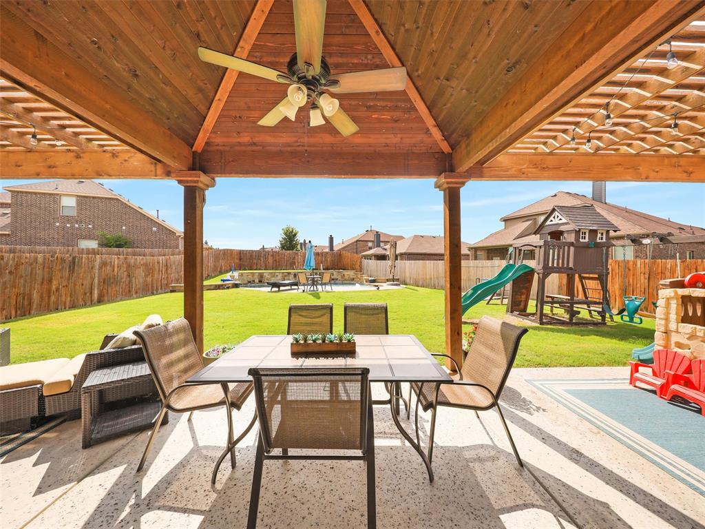 a view of a patio with a table chairs and a backyard