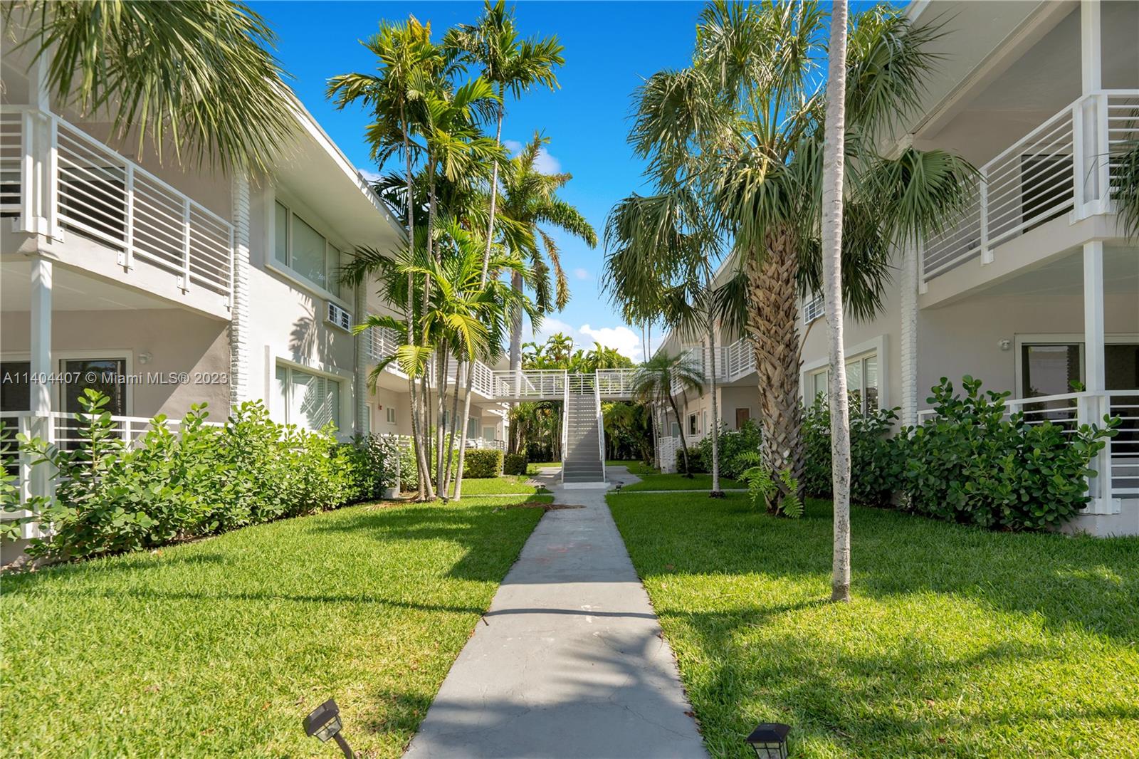 a pathway of a house with a yard