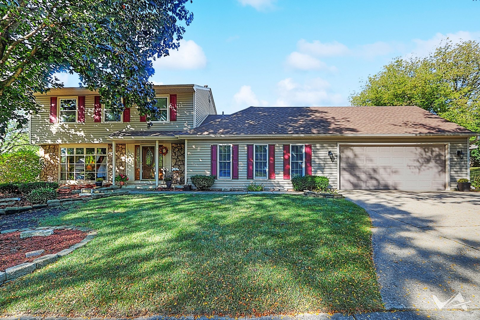 a front view of a house with a garden