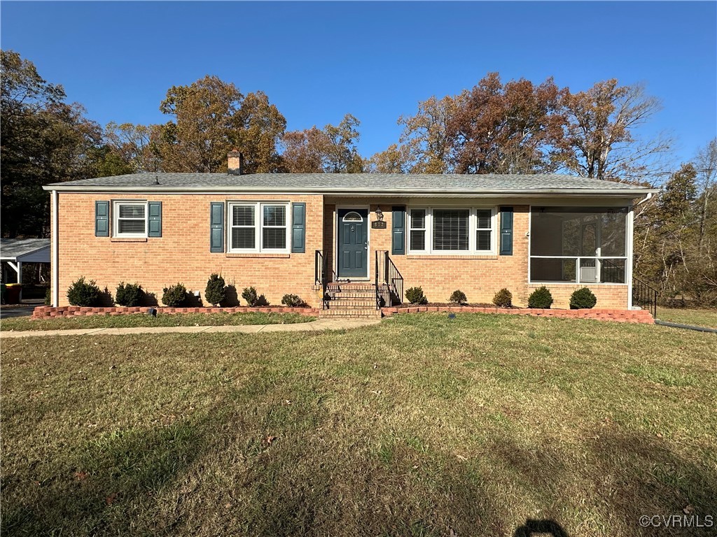 Ranch-style home with a front lawn