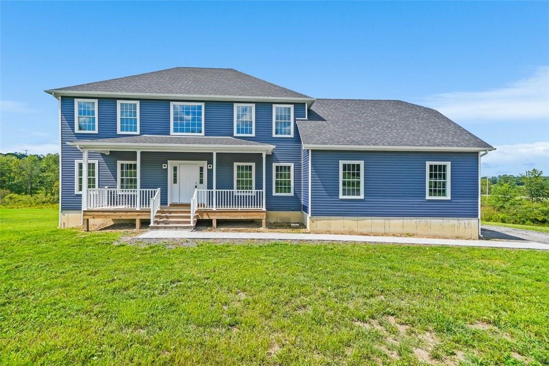 CUSTOM Colonial house featuring covered porch.