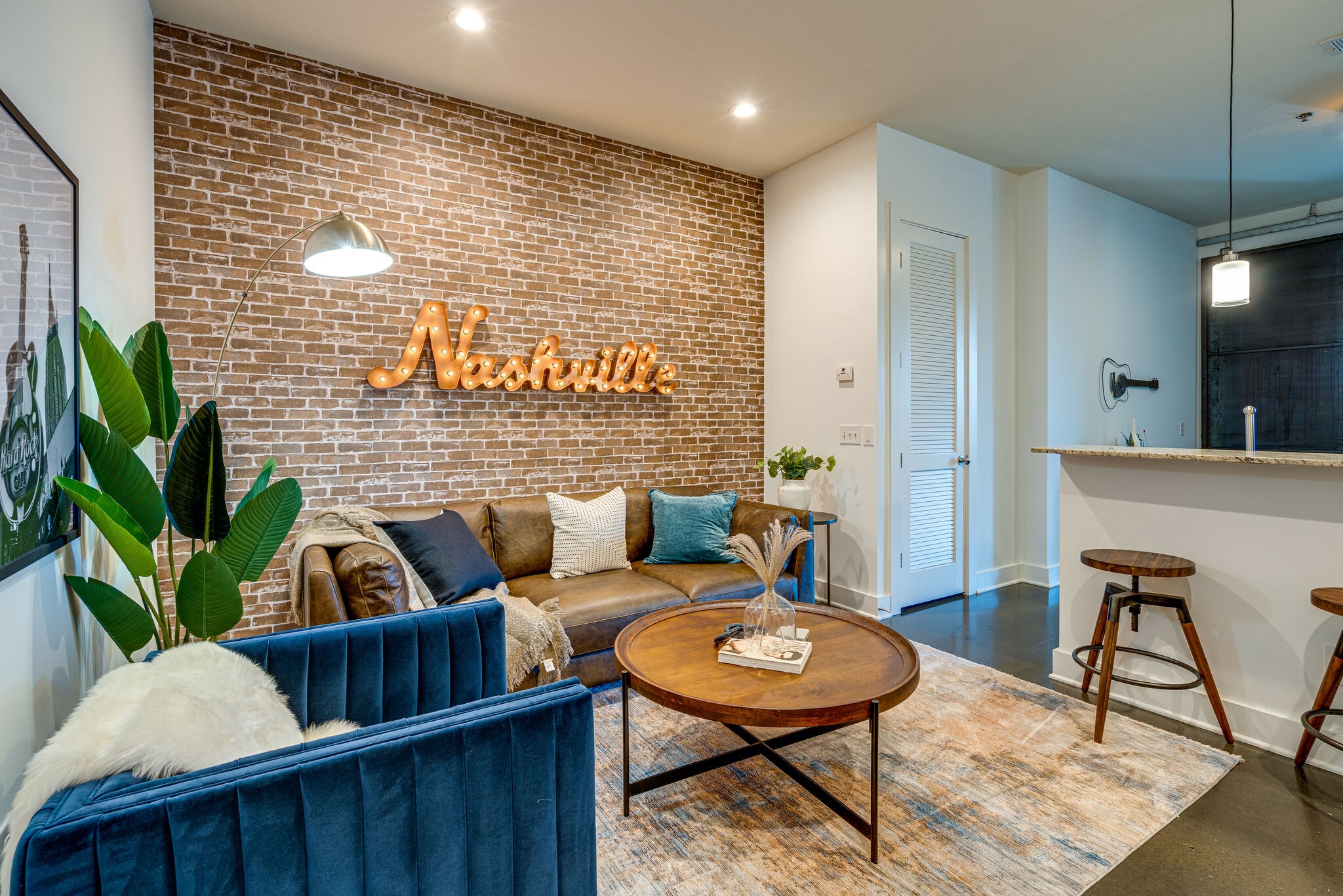 a living room with furniture and a potted plant