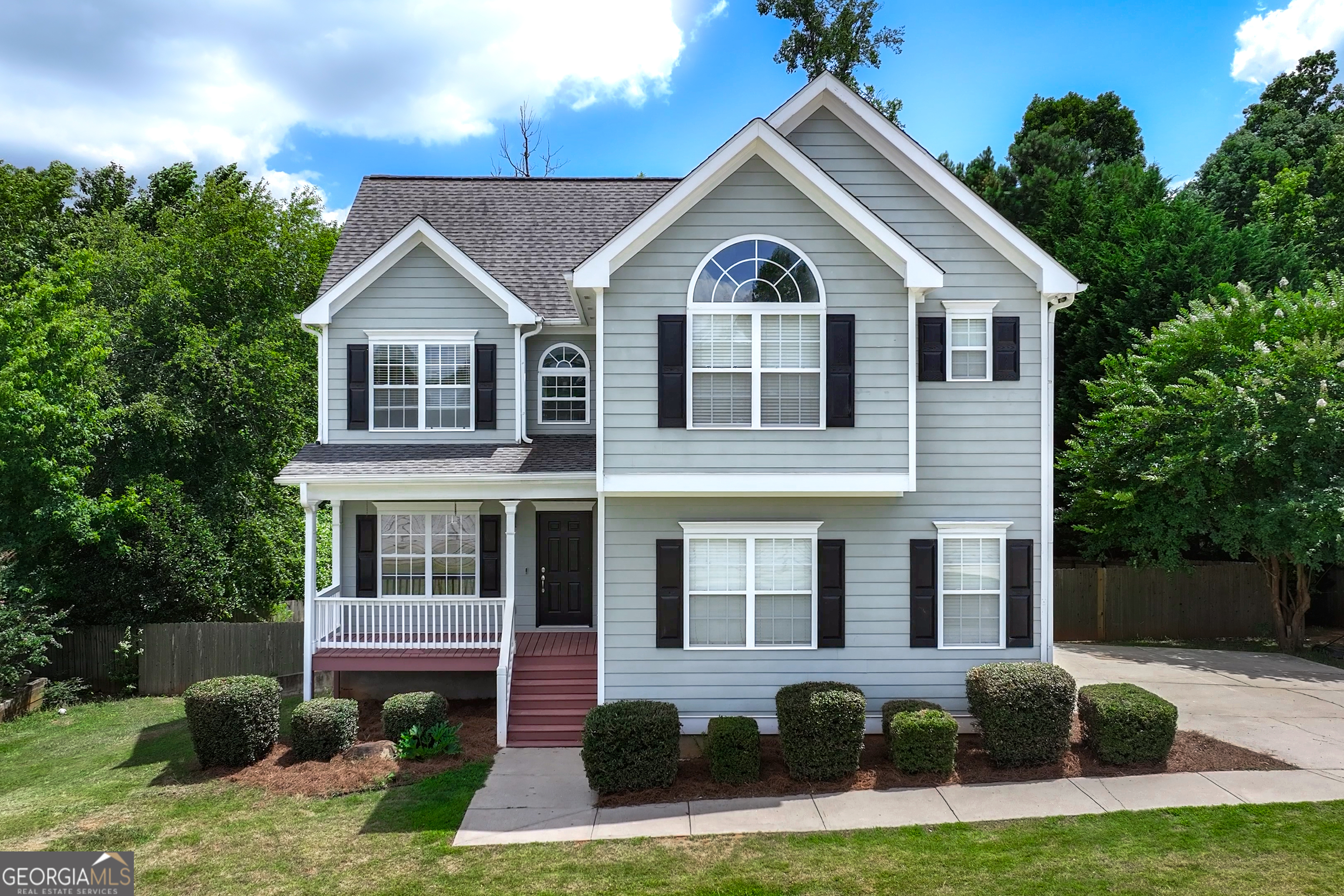 a front view of a house with garden