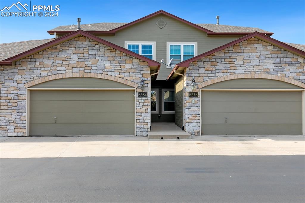 a front view of a house with garage