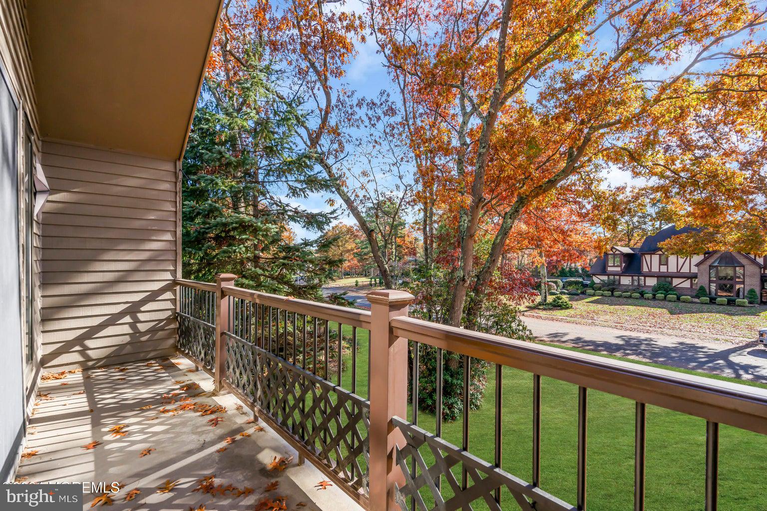 a view of a wooden deck next to a yard