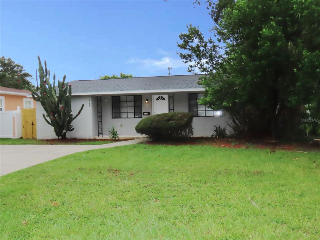 a front view of house with yard and green space