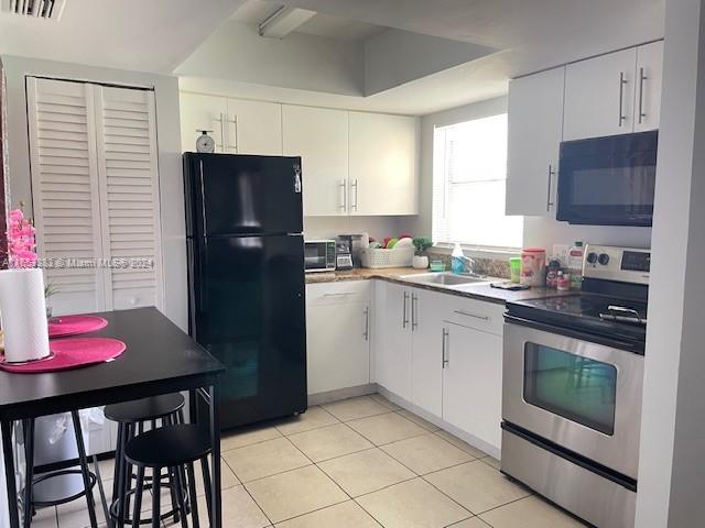 a kitchen with a refrigerator stove top oven and sink