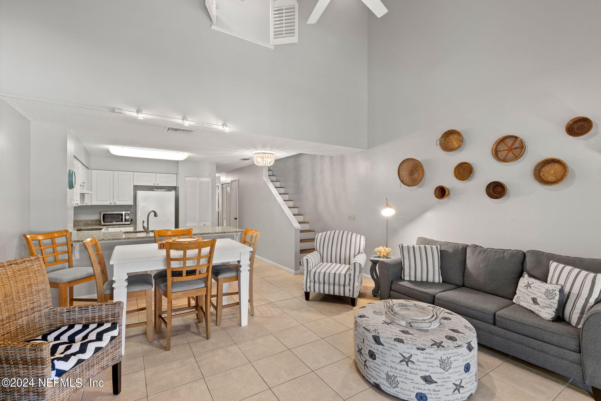 a living room with furniture and kitchen view