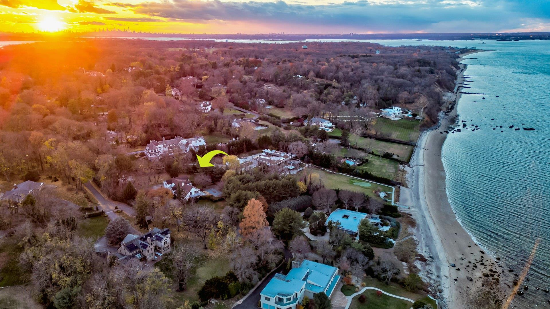 Aerial view at dusk with a beach view and a water view