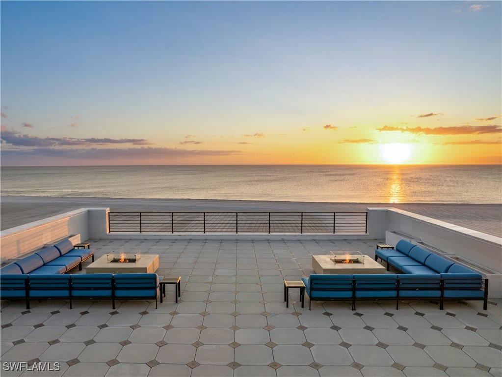 a roof deck with table and chairs