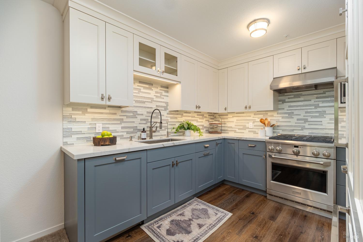 a kitchen with a sink stove and cabinets