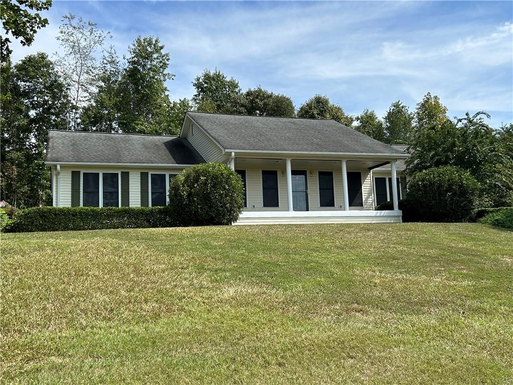 a front view of a house with a garden