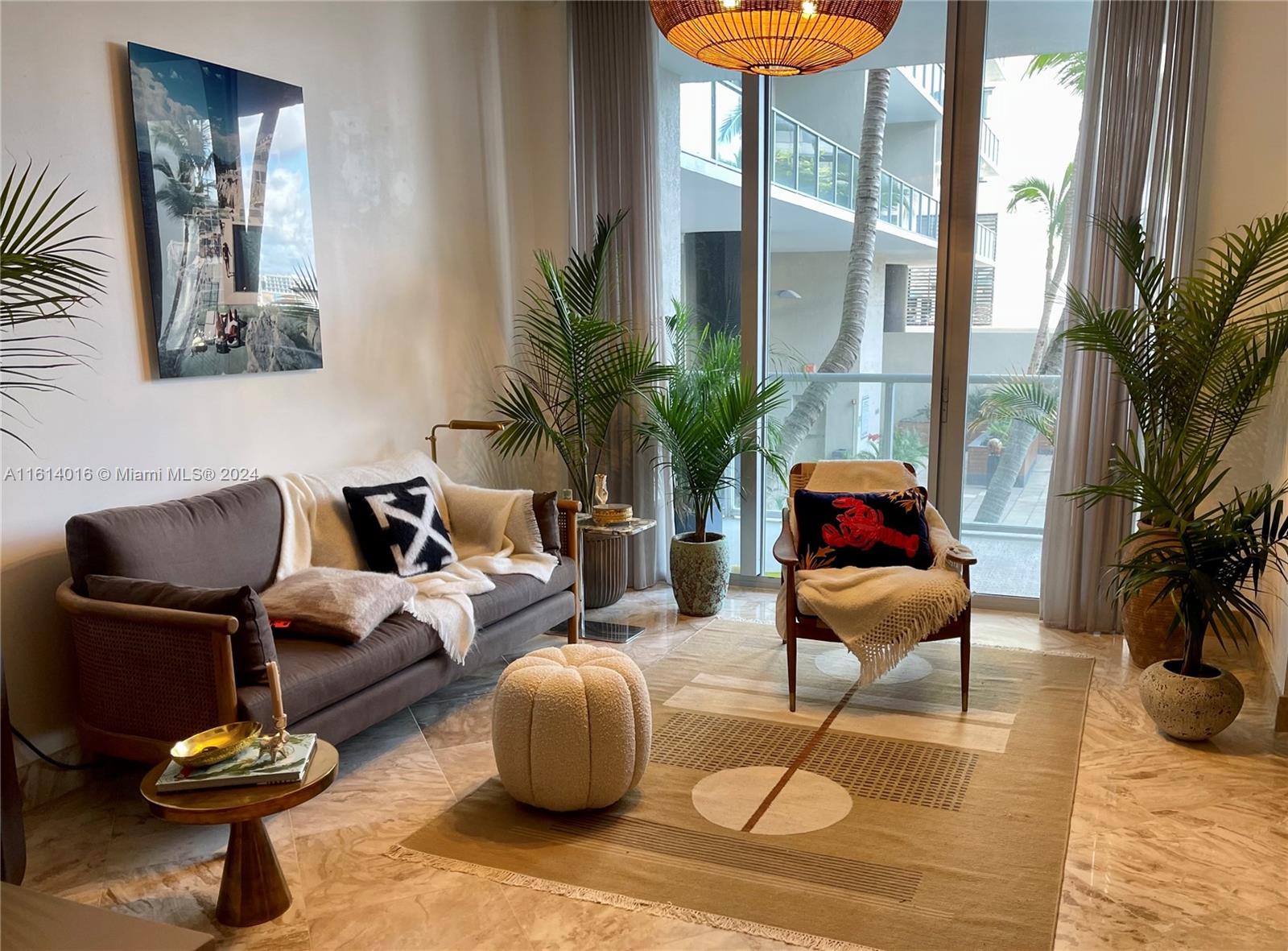 a living room with furniture and a potted plant