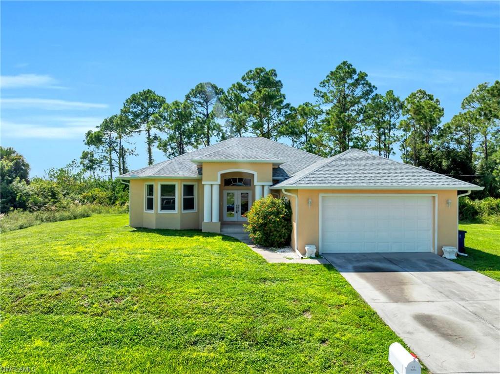 a front view of a house with a garden