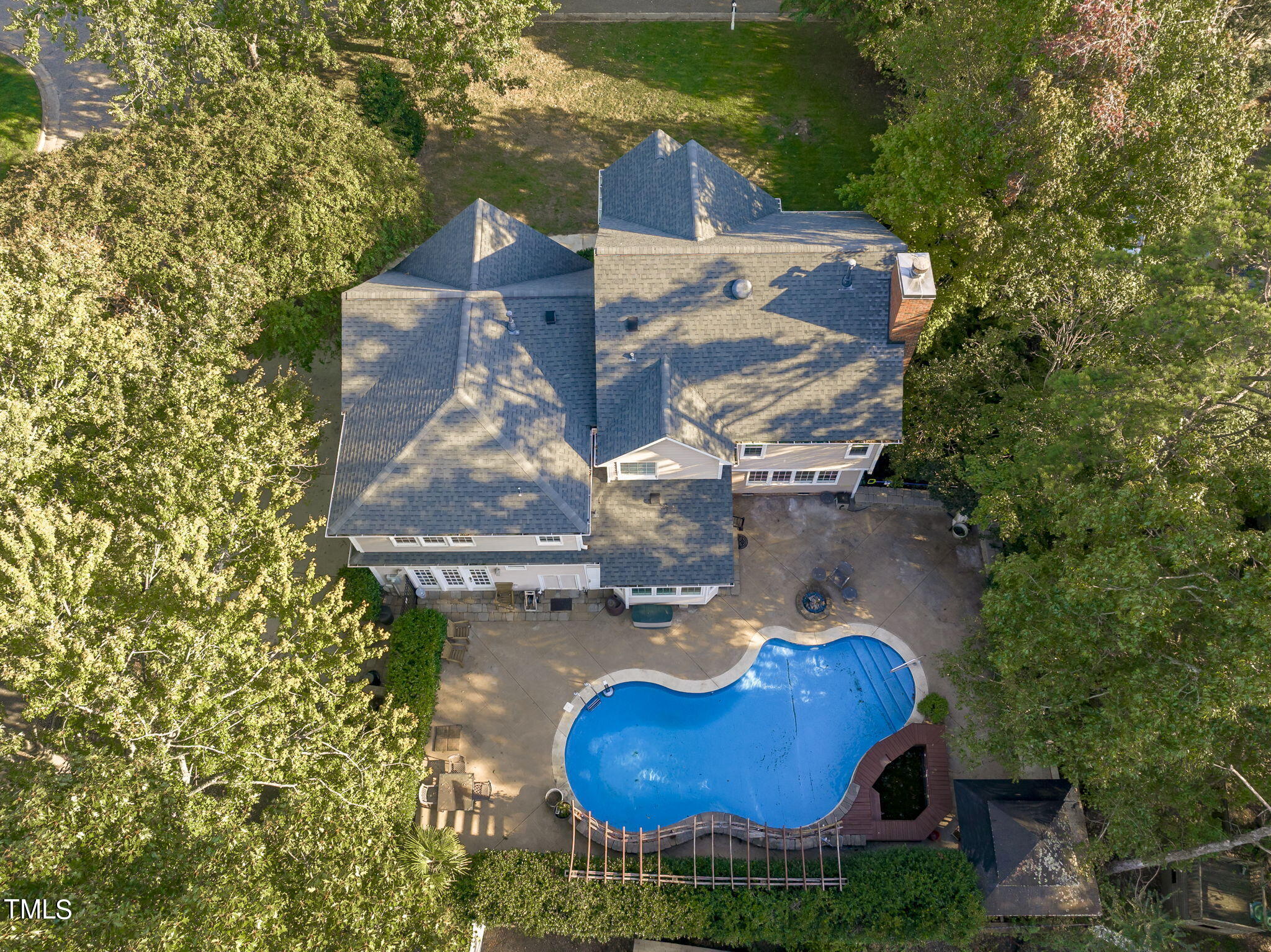 an aerial view of a house with garden space and street view