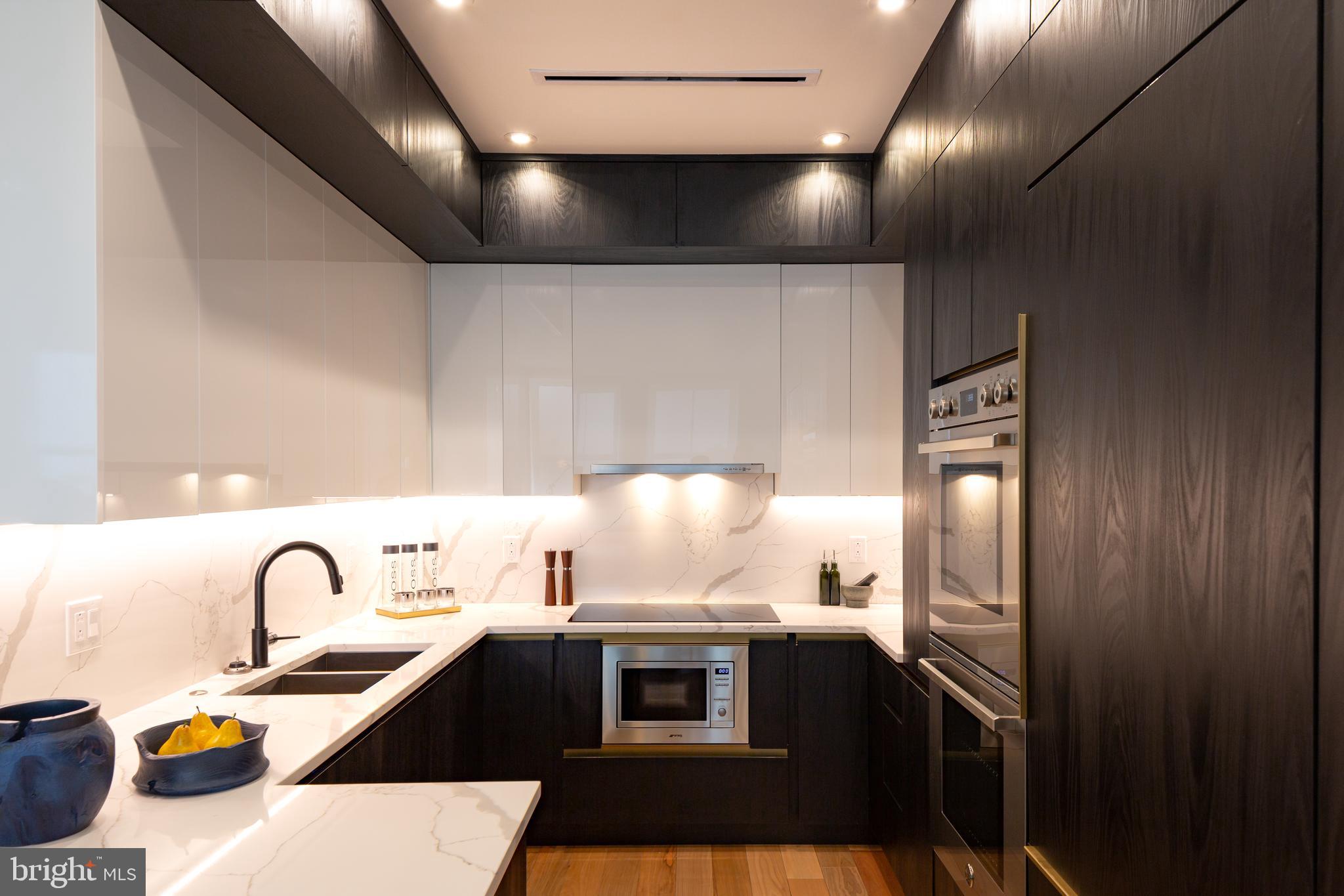 a kitchen with a refrigerator and a stove top oven