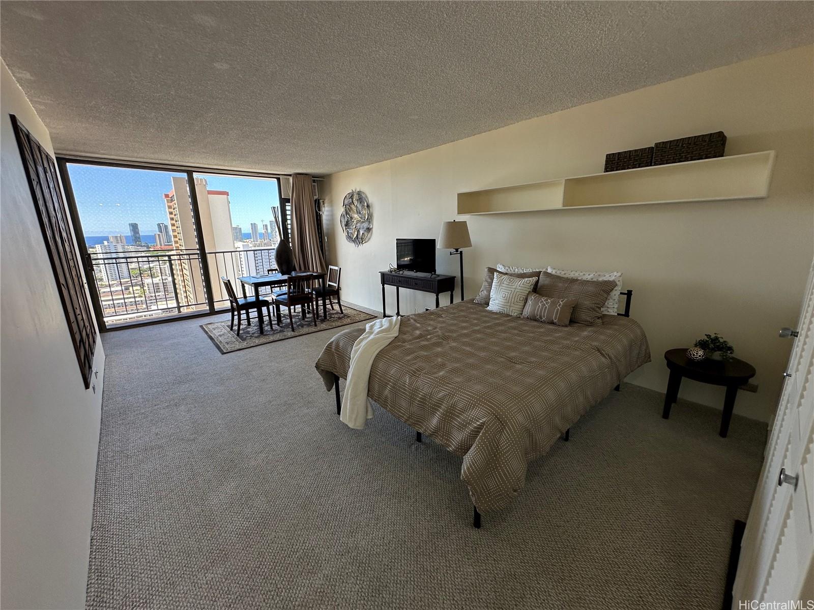 a living room with furniture and a flat tv screen next to a large window