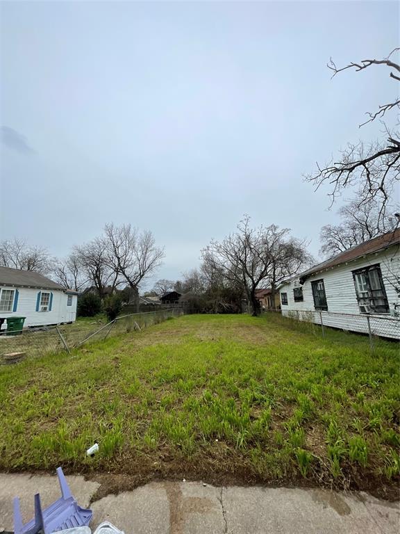 a view of a house with a big yard and large trees