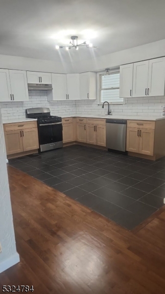 a view of a kitchen with electric appliances