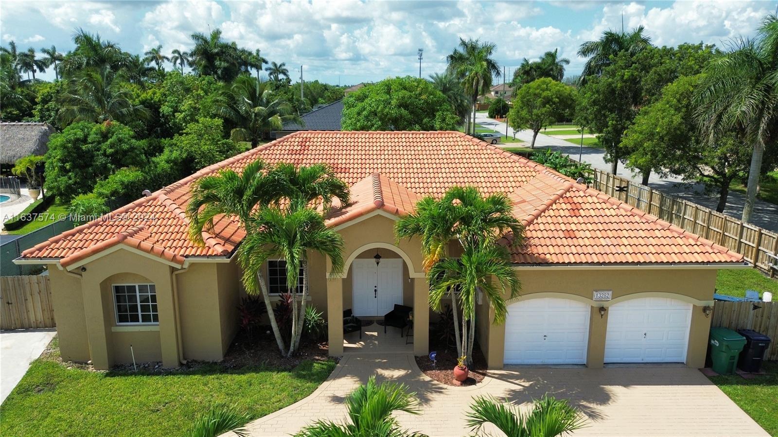 a front view of house with a garden