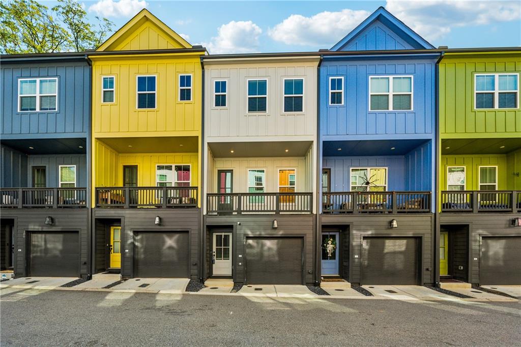 a front view of a residential apartment building with a yard