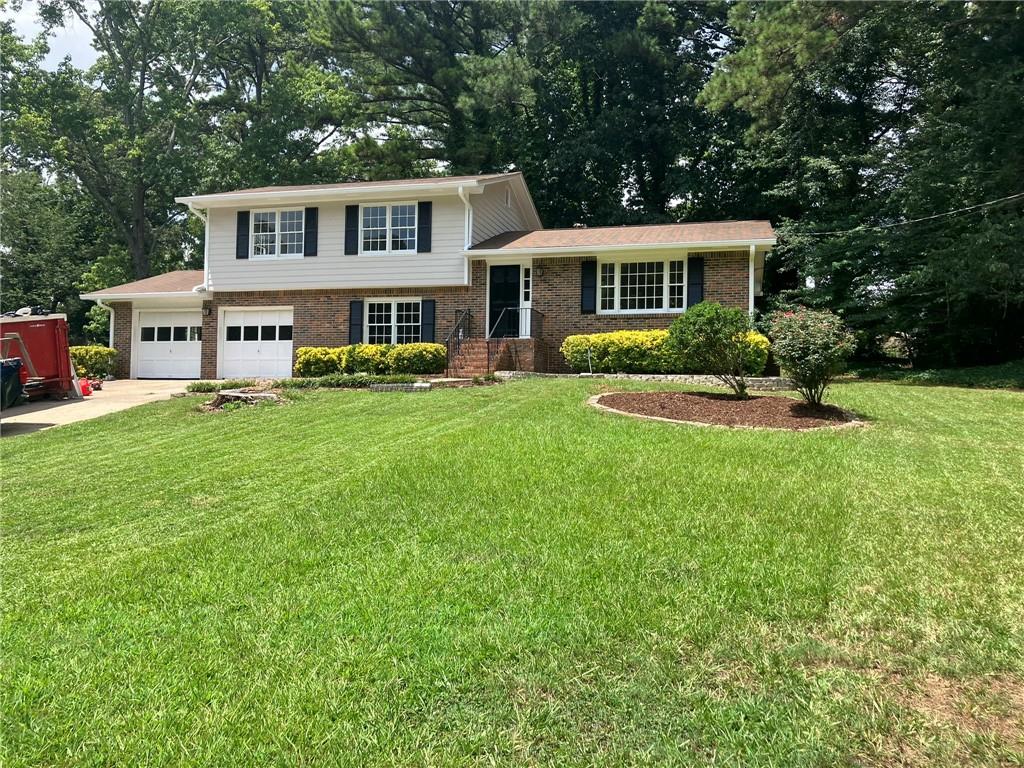 a front view of house with yard and green space