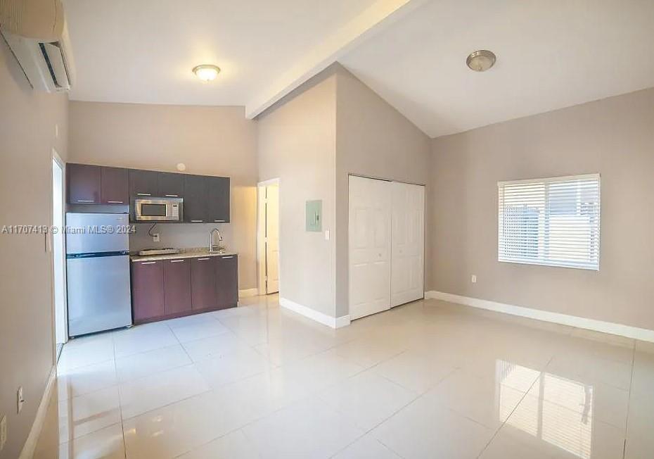 a kitchen with stainless steel appliances a sink and a refrigerator