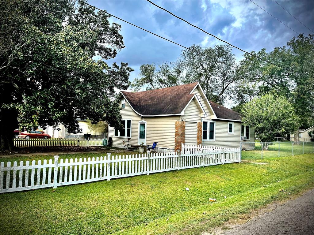 a front view of a house with a garden and yard