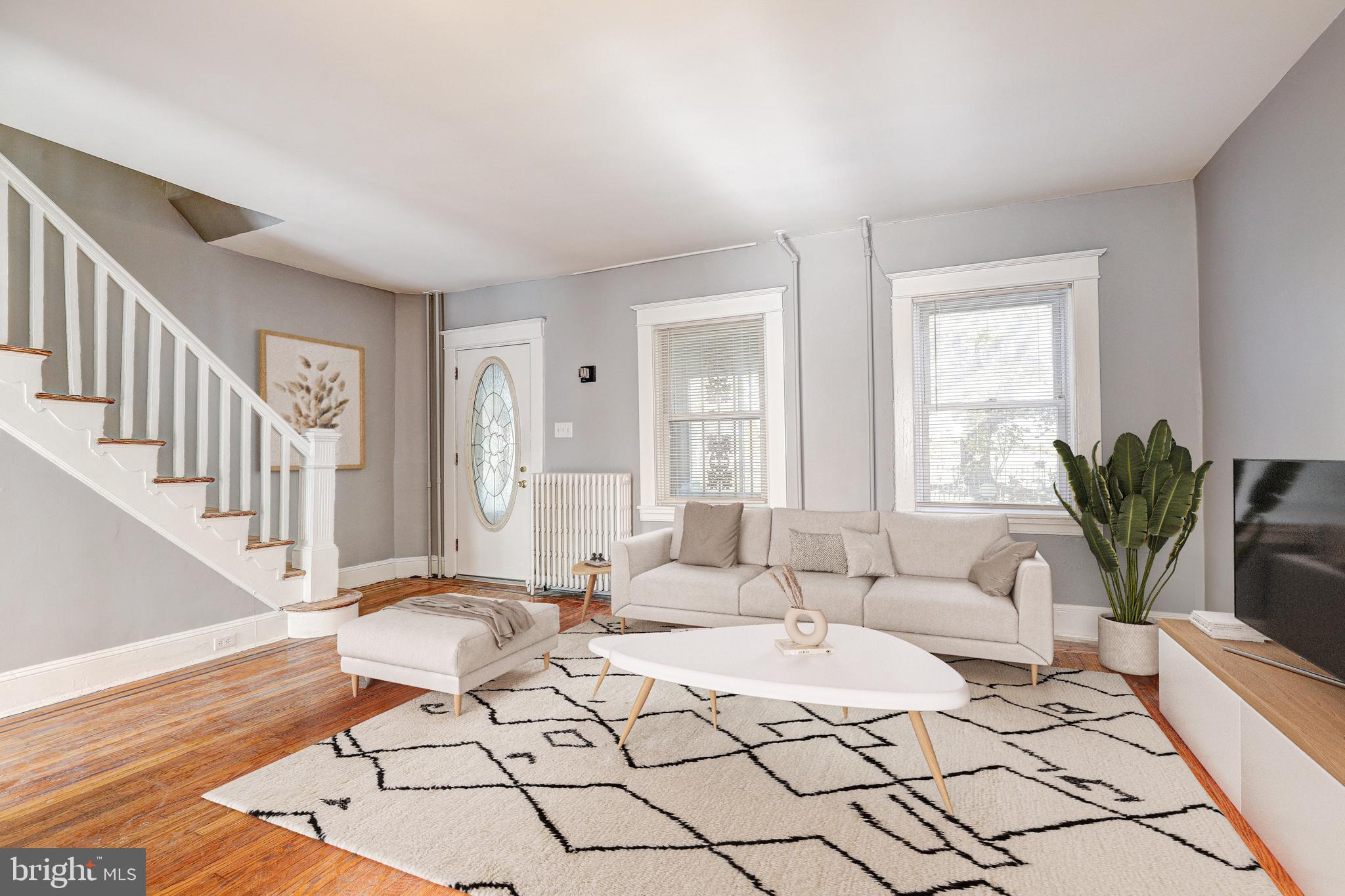 a living room with furniture potted plant and a table