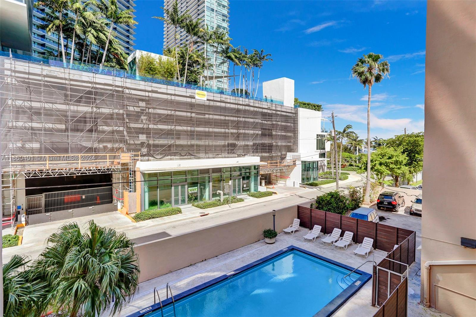 a view of swimming pool with outdoor seating and plants