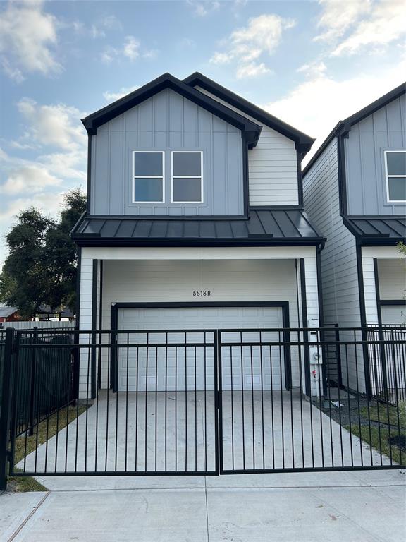 a front view of a house with iron fence