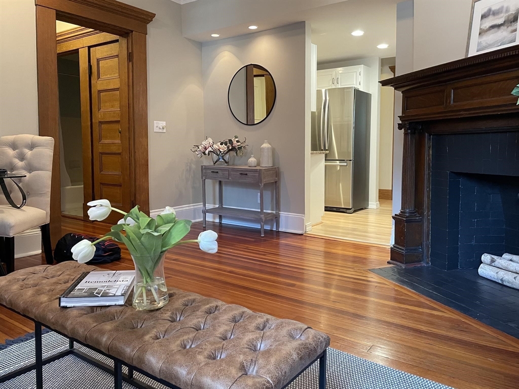 a living room with dining table furniture and wooden floor