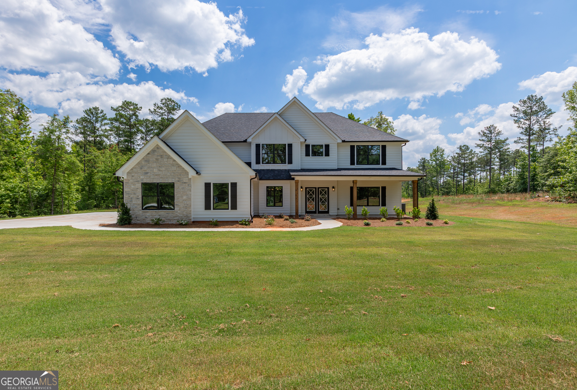 a front view of a house with a garden