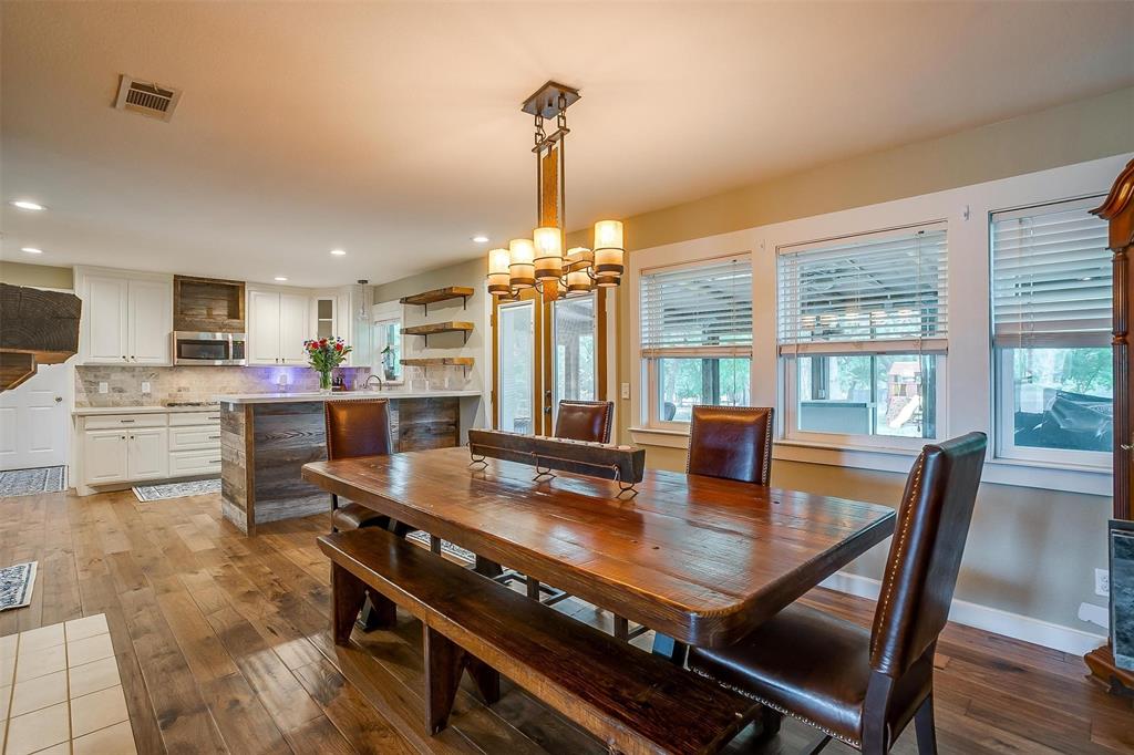 a dining room with furniture a chandelier and wooden floor