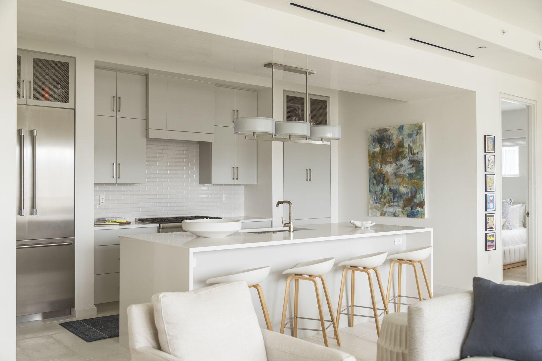 a kitchen with stainless steel appliances granite countertop a sink and a refrigerator