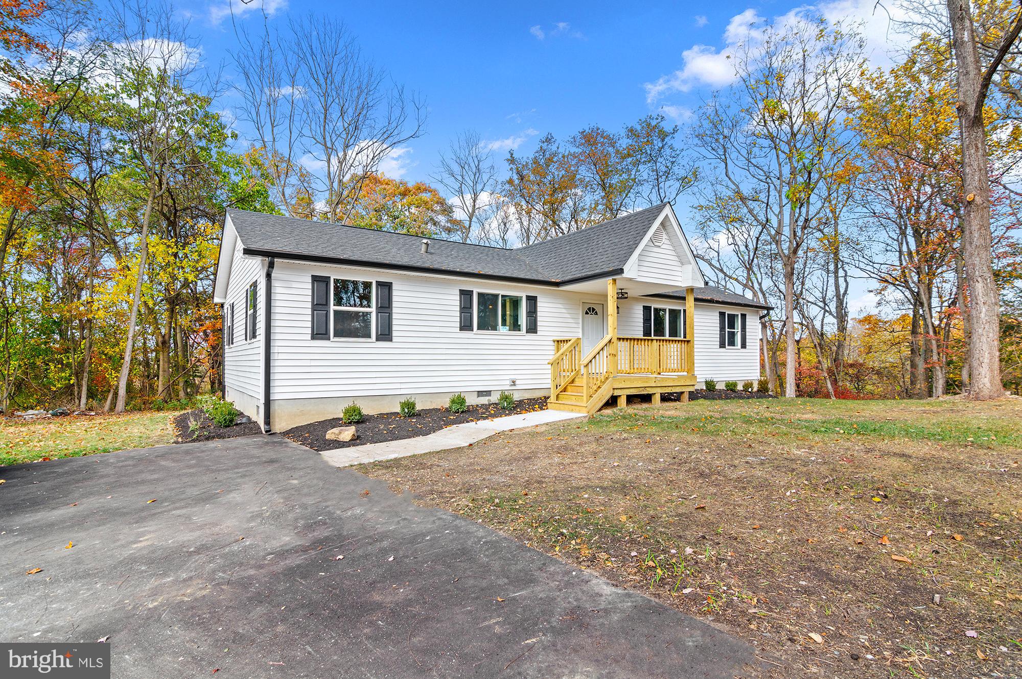 a view of a house with a yard and pathway