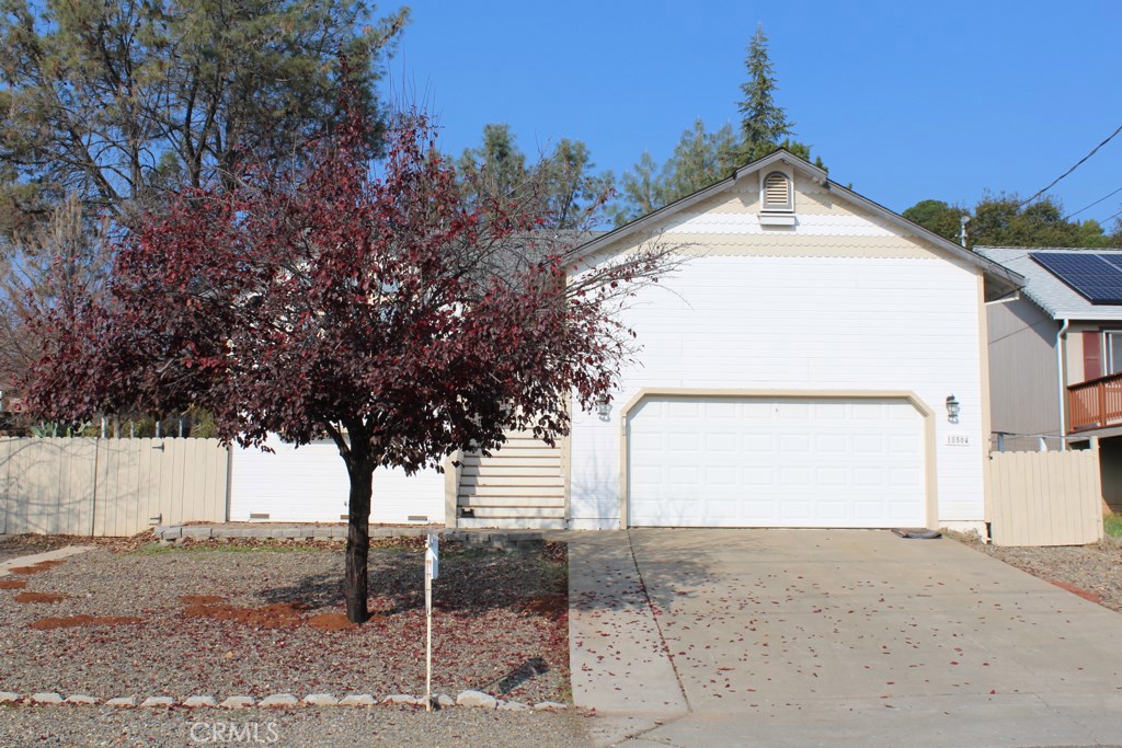 a view of a house with a tree