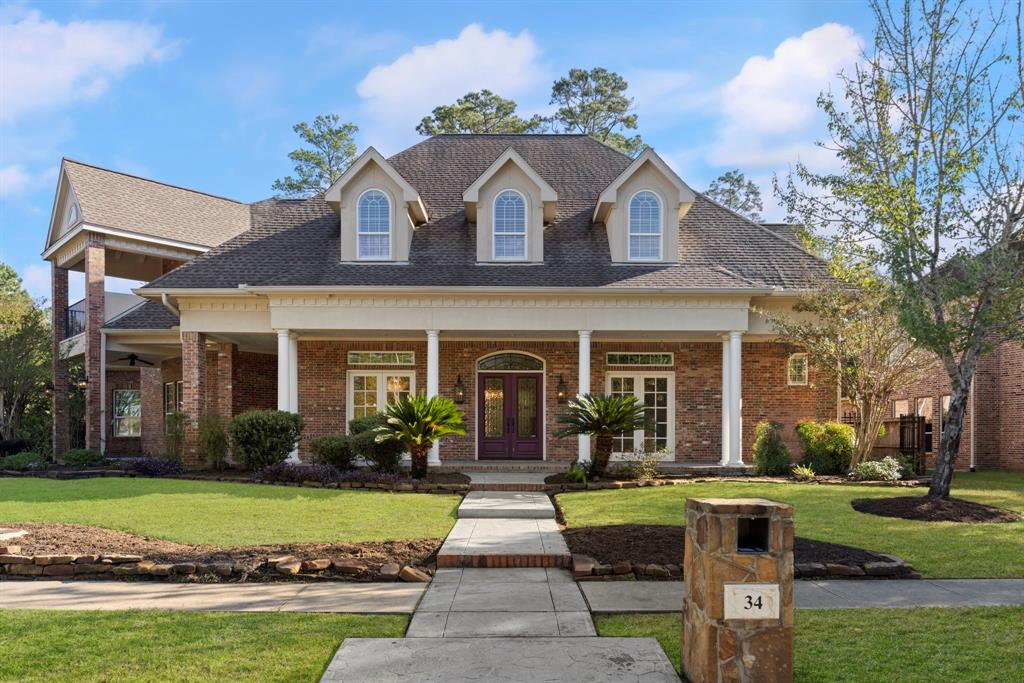 a front view of a house with garden and porch