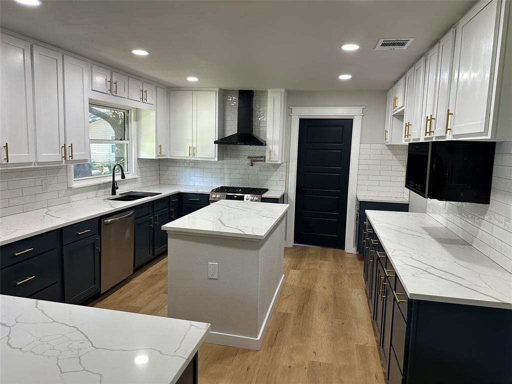 a kitchen with a sink a stove and refrigerator