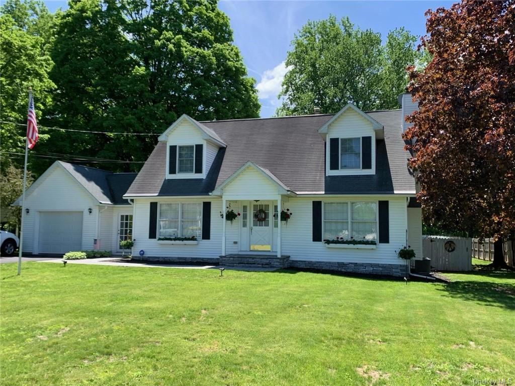 a front view of house with yard and green space