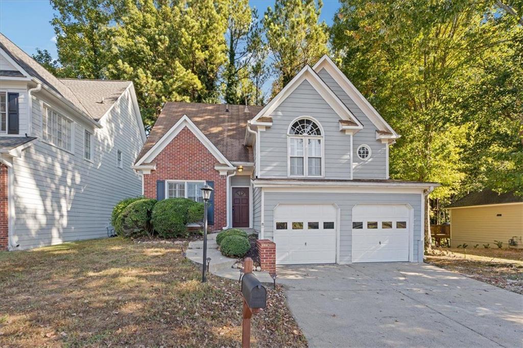 a front view of a house with a yard and garage