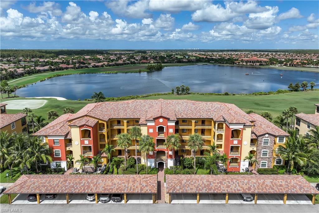 an aerial view of a house with a garden and lake view