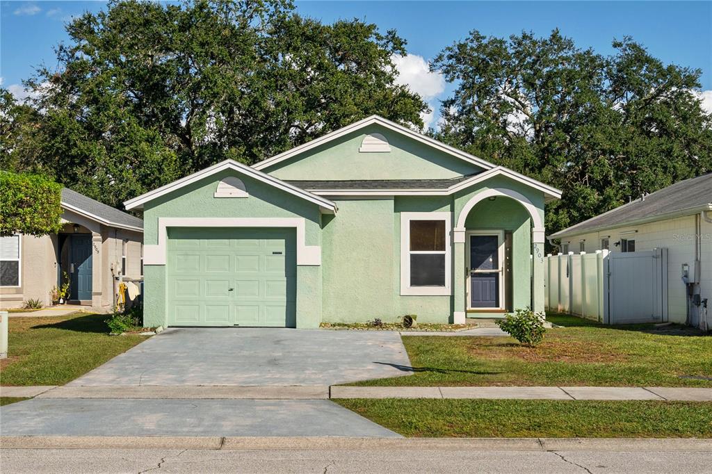 a front view of a house with a yard and garage