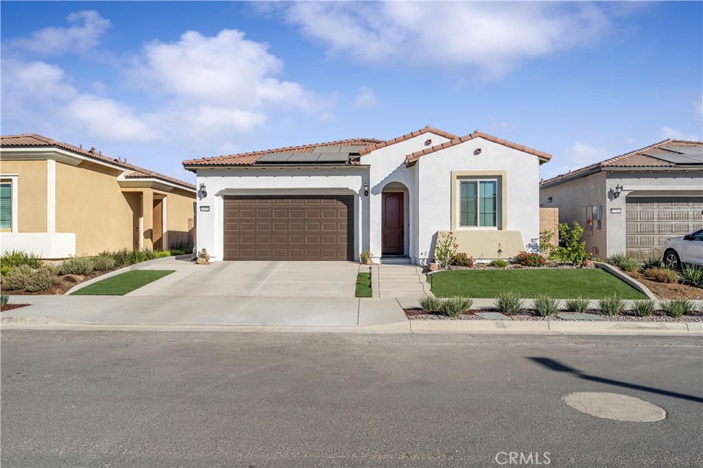 a front view of a house with a yard and garage