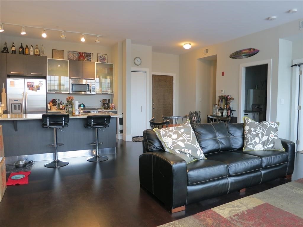 a living room with furniture and kitchen view