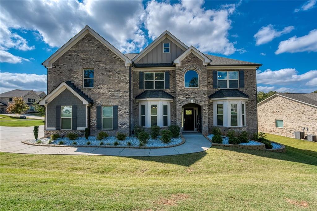 a front view of house with yard and green space