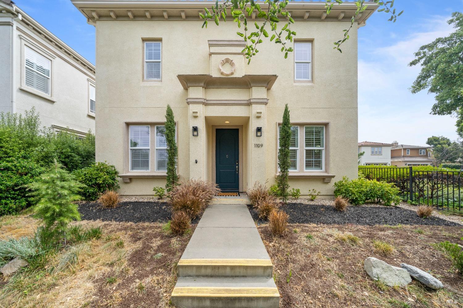 a front view of a house with garden