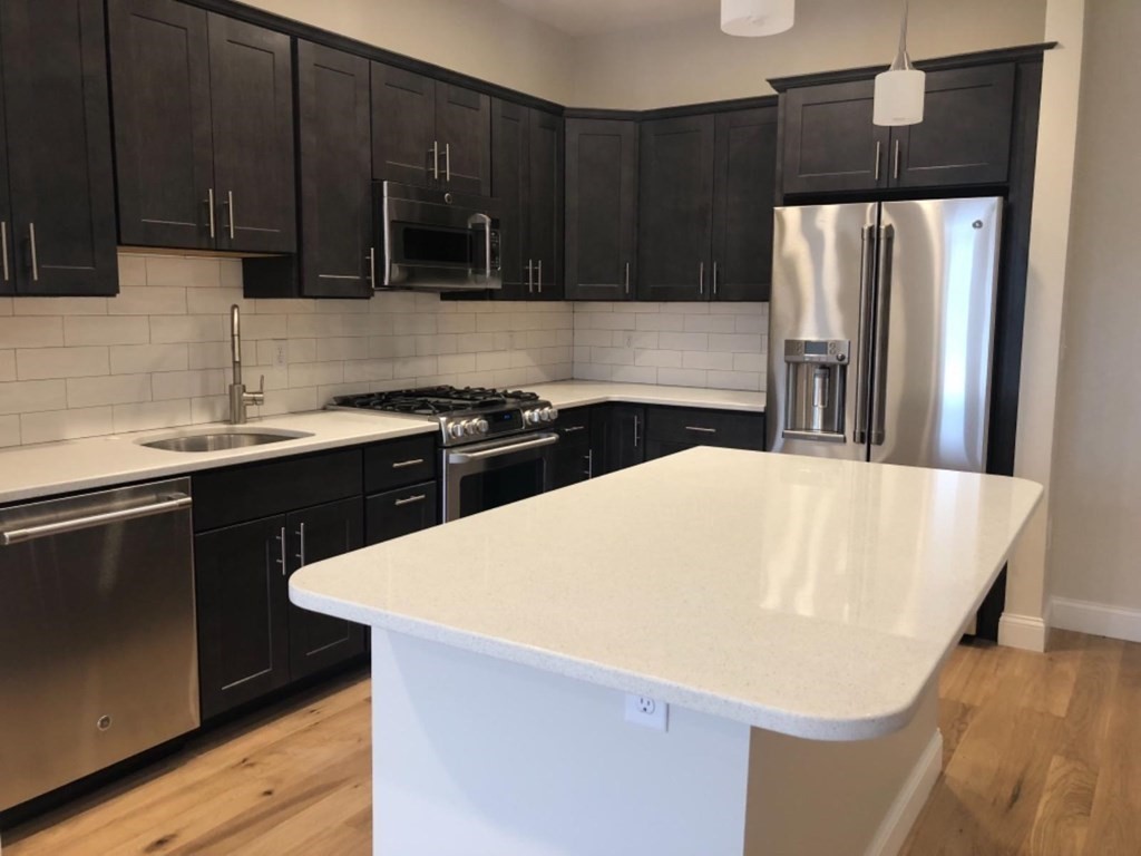 a kitchen with a sink and a refrigerator